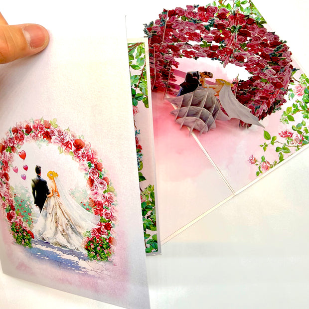 Blonde - Meridian Pink & Red Rose Arch with Bride & Groom Created by Origami Pop Cards – 3D Pop Up Greeting Cards, Australian Design & Handmade, 3D Pop Up Magical Paper Cards, Handmade Pop Up Cards Celebrate Love Anniversary Heart Fell and Romantic