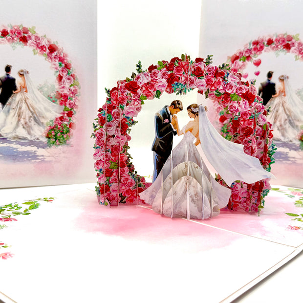 Brunette - Meridian Pink & Red Rose Arch with Bride & Groom Created by Origami Pop Cards – 3D Pop Up Greeting Cards, Australian Design & Handmade, 3D Pop Up Magical Paper Cards, Handmade Pop Up Cards Celebrate Love Anniversary Heart Fell and Romantic