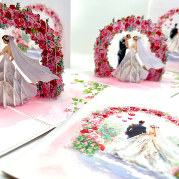 Brunette - Meridian Pink & Red Rose Arch with Bride & Groom Created by Origami Pop Cards – 3D Pop Up Greeting Cards, Australian Design & Handmade, 3D Pop Up Magical Paper Cards, Handmade Pop Up Cards Celebrate Love Anniversary Heart Fell and Romantic