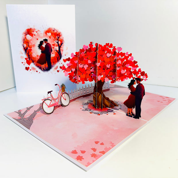 Couple in Love under a Hot Pink Love Heart Cherry Blossom Tree 3D POP UP GREETING CARD - Created by Origami Pop Cards Australian Design & Handmade 3D Pop Up Magical Paper Cards, Handmade Pop Up Cards Celebrate Love Anniversary Heart Fell and Romantic