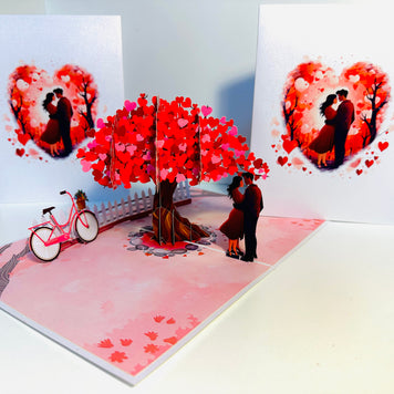 Couple in Love under a Hot Pink Love Heart Cherry Blossom Tree 3D POP UP GREETING CARD - Created by Origami Pop Cards Australian Design & Handmade 3D Pop Up Magical Paper Cards, Handmade Pop Up Cards Celebrate Love Anniversary Heart Fell and Romantic