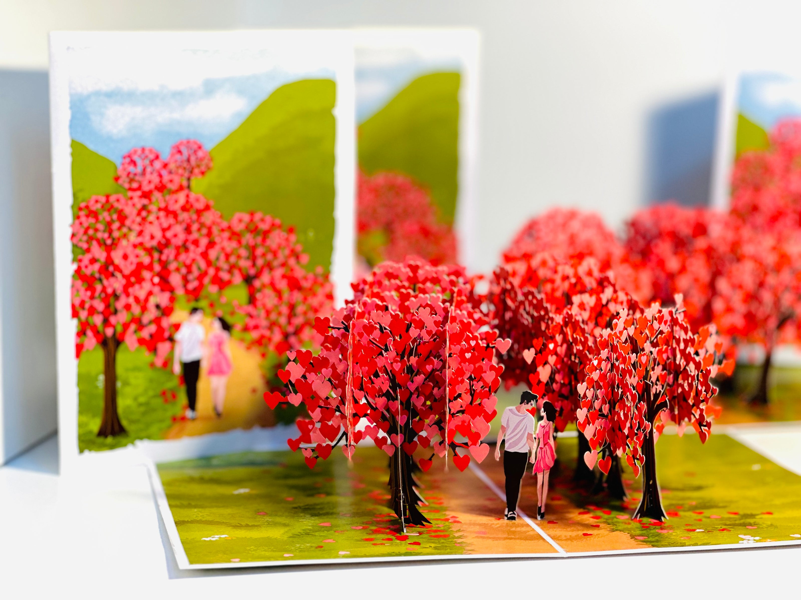 Love Heart Cherry Blossom Forest with a Couple in Love 3D POP UP GREETING CARD - Created by Origami Pop Cards Australian Design & Handmade 3D Pop Up Magical Paper Cards, Handmade Pop Up Cards Happy Valentine's Day Celebrate Love Heart Fell and Romantic