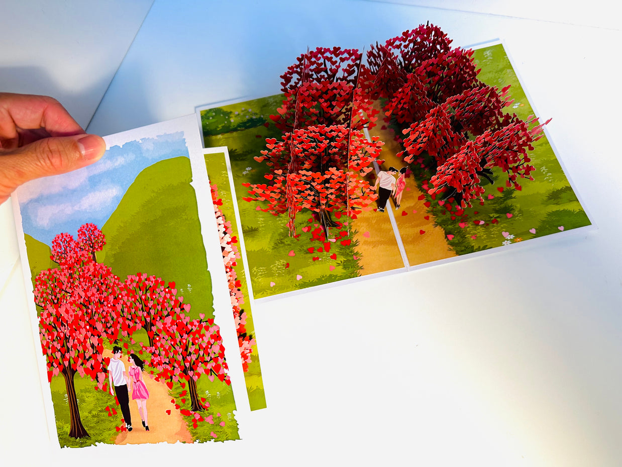 Love Heart Cherry Blossom Forest with a Couple in Love 3D POP UP GREETING CARD - Created by Origami Pop Cards Australian Design & Handmade 3D Pop Up Magical Paper Cards, Handmade Pop Up Cards Happy Valentine's Day Celebrate Love Heart Fell and Romantic