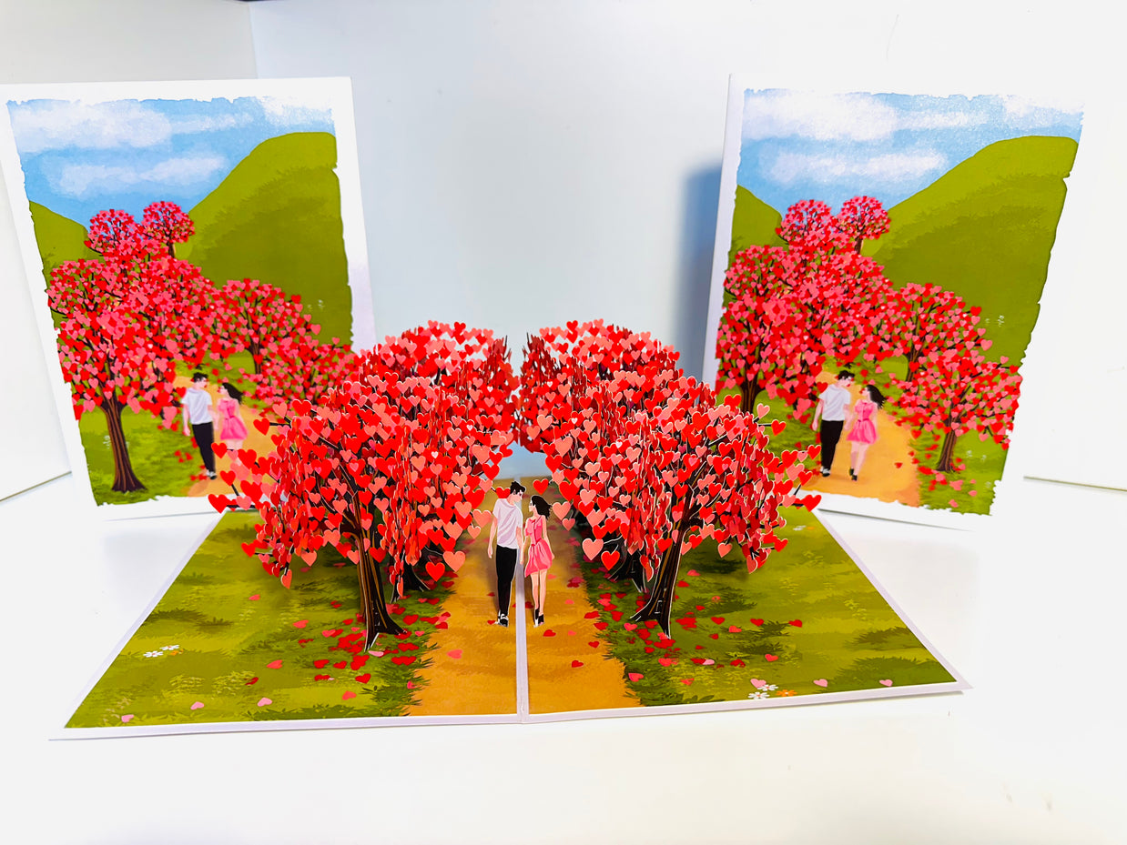 Love Heart Cherry Blossom Forest with a Couple in Love 3D POP UP GREETING CARD - Created by Origami Pop Cards Australian Design & Handmade 3D Pop Up Magical Paper Cards, Handmade Pop Up Cards Happy Valentine's Day Celebrate Love Heart Fell and Romantic