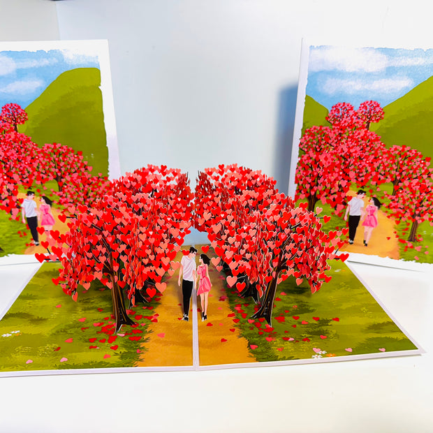 Love Heart Cherry Blossom Forest with a Couple in Love 3D POP UP GREETING CARD - Created by Origami Pop Cards Australian Design & Handmade 3D Pop Up Magical Paper Cards, Handmade Pop Up Cards Happy Valentine's Day Celebrate Love Heart Fell and Romantic